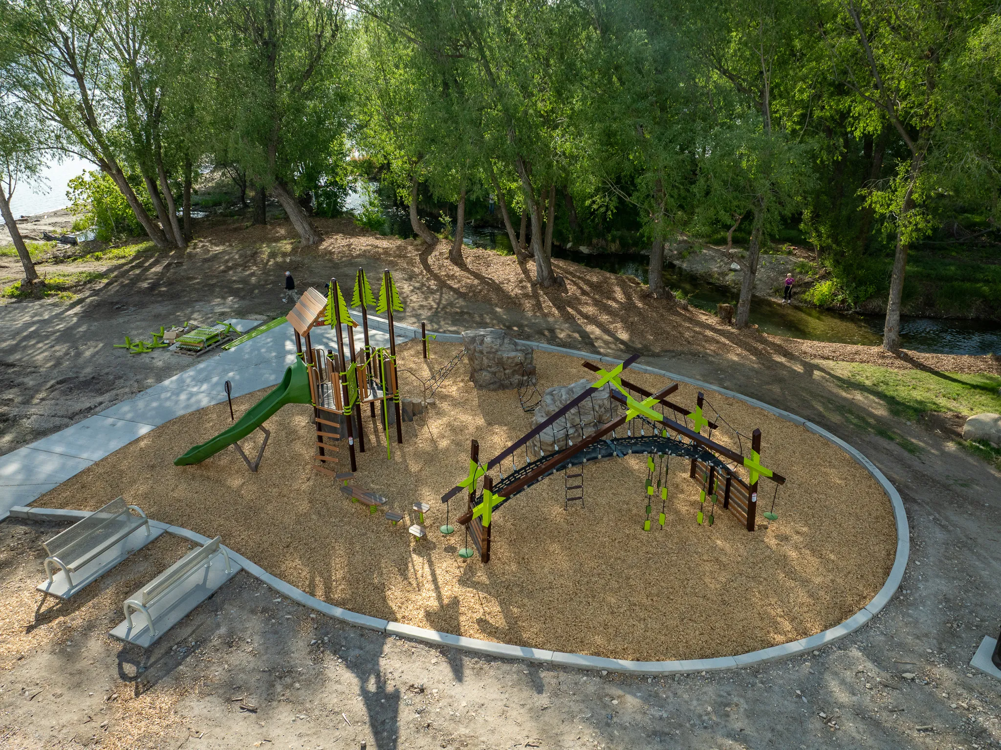 Drone landscape view of a tree-shaded playground at American Fork Boat Harbor park, Utah