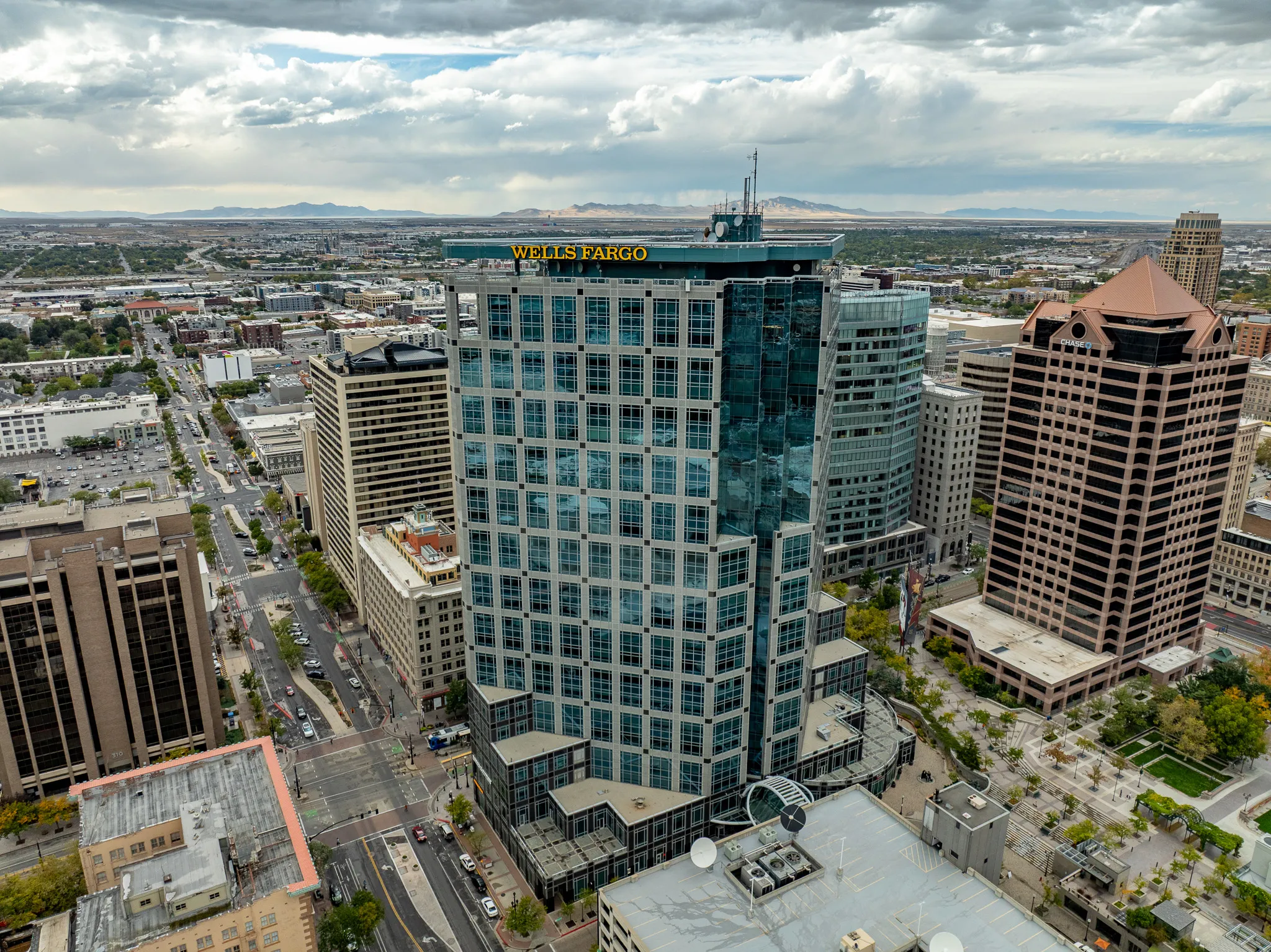 Aerial drone shot of the Wells Fargo Center high-rise tower in downtown Salt Lake City, Utah